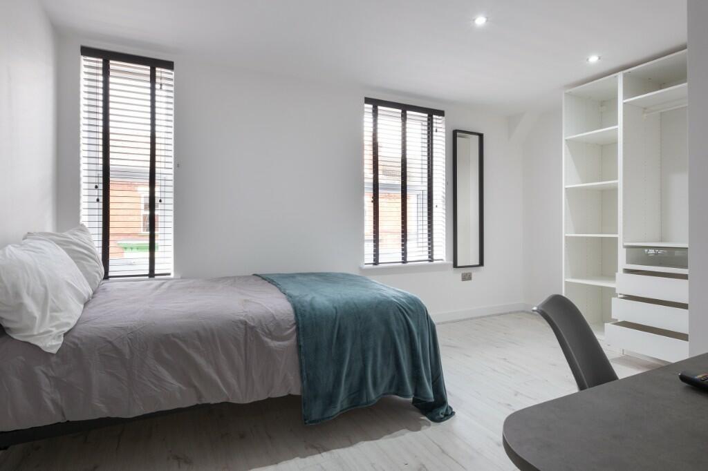Bright and modern double bedroom featuring two ...