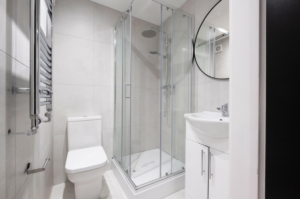 Modern clean bathroom featuring a shower enclos...
