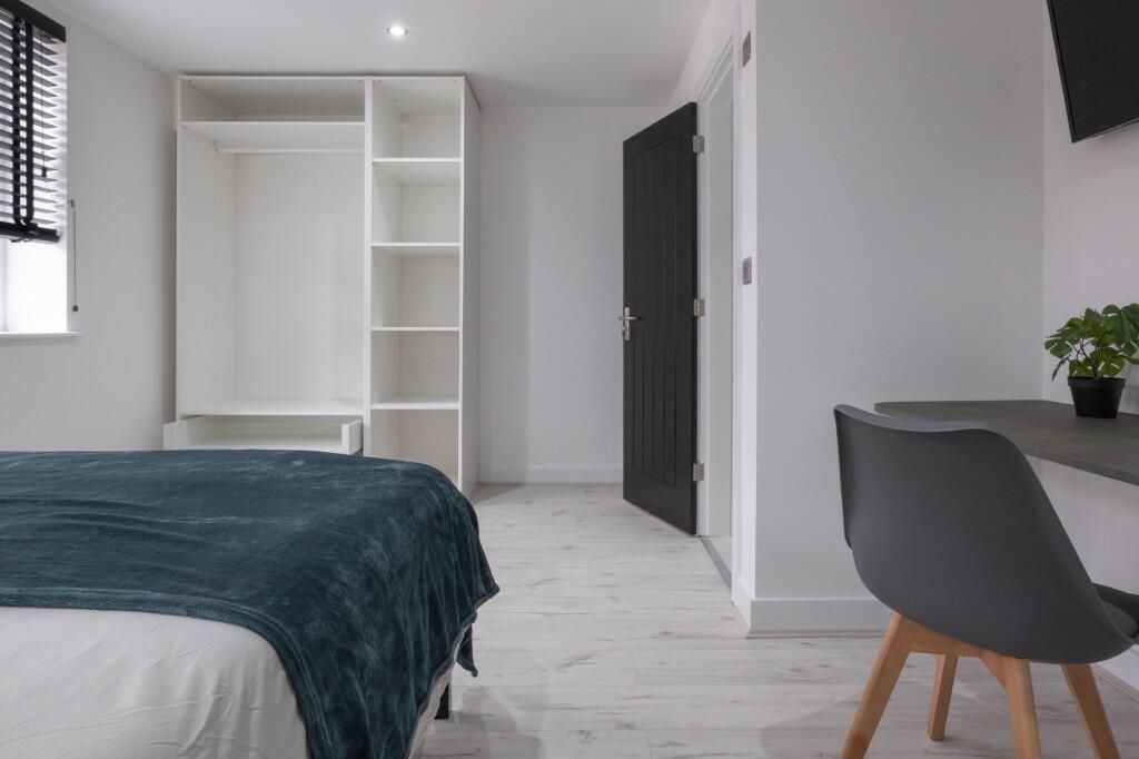 Bright, modern double bedroom with a fitted war...