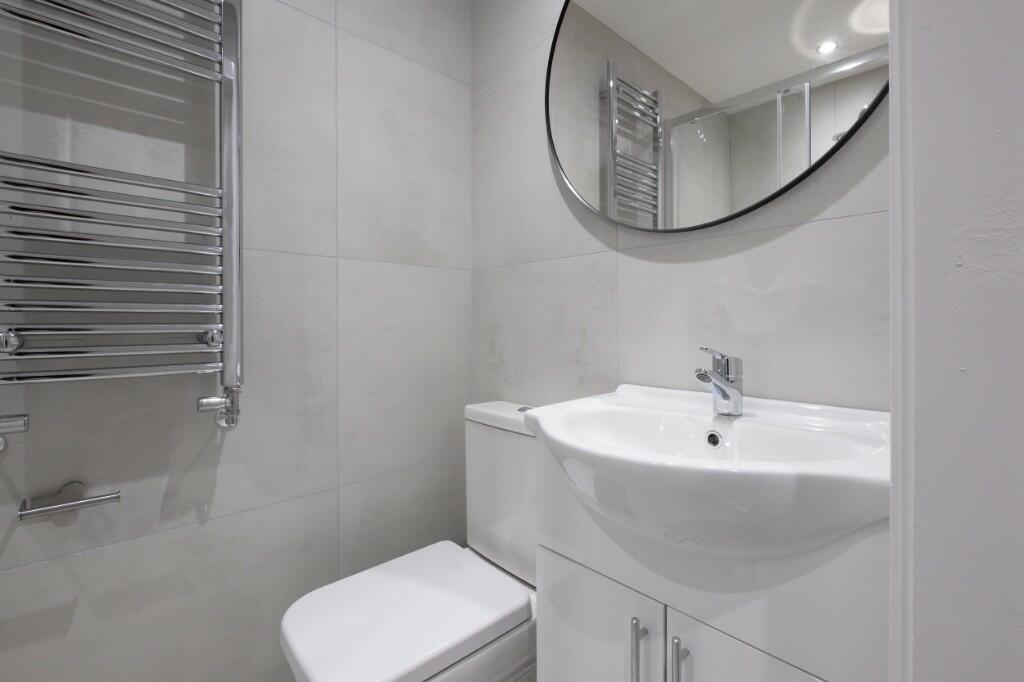 A clean and modern bathroom with a large bathtu...