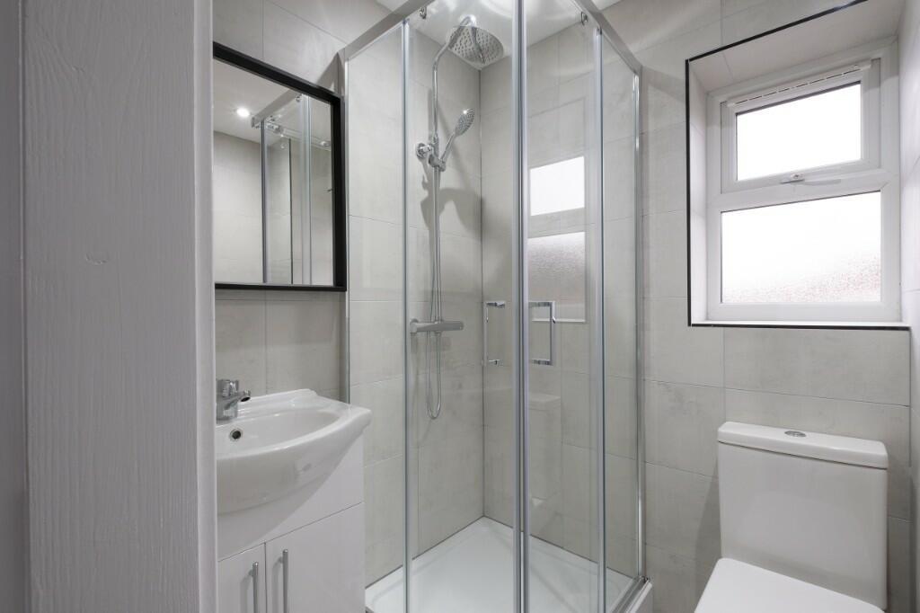 A clean and modern bathroom featuring a spaciou...