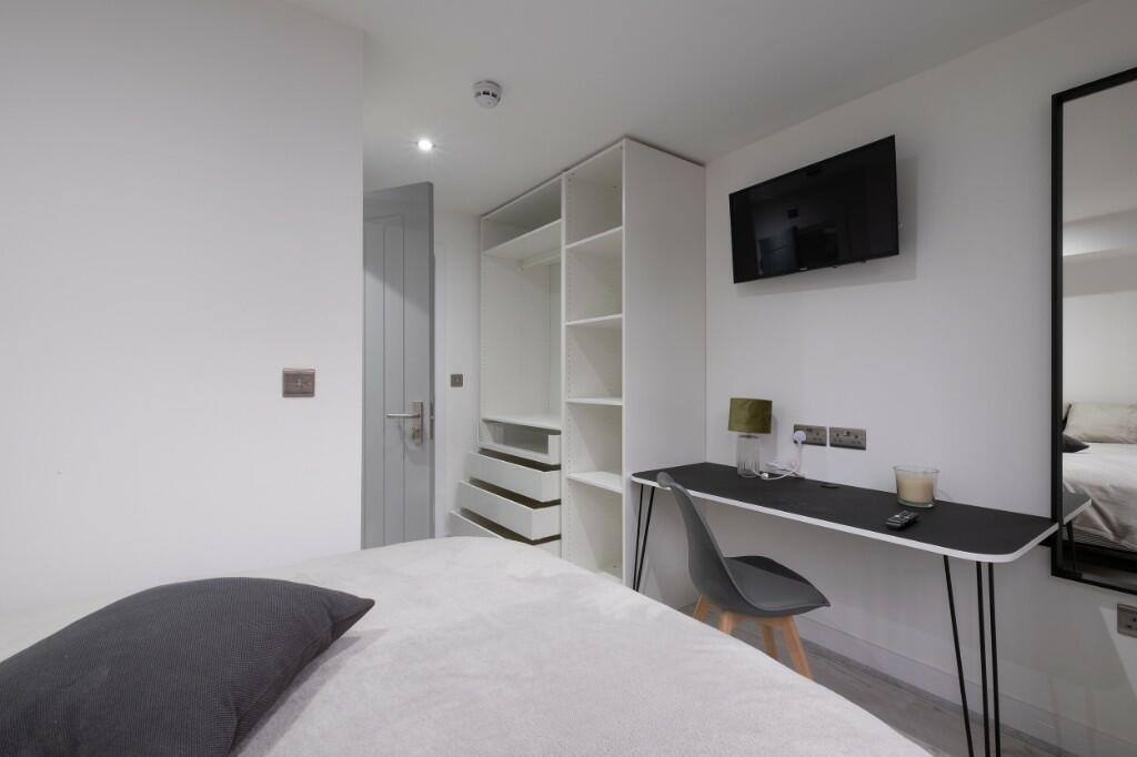 A modern, well-maintained bedroom featuring a c...