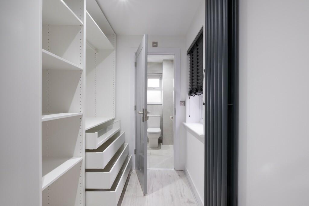 A clean and bright bathroom featuring a large b...
