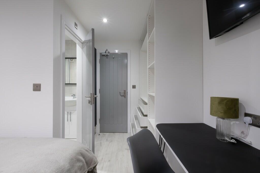 A bright, well-maintained bedroom featuring a n...