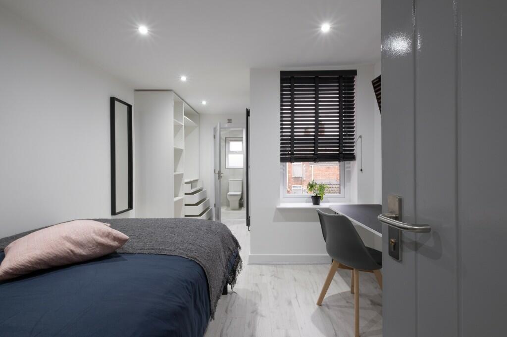 A bright and modern bedroom featuring a spaciou...