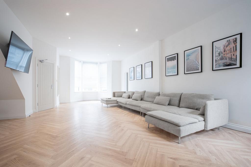 Bright, contemporary living room with a long gr...