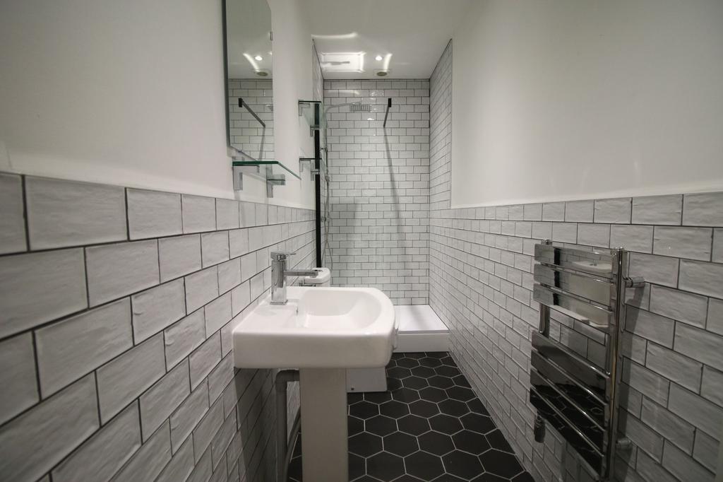 Contemporary tiled bathroom with a walk-in show...