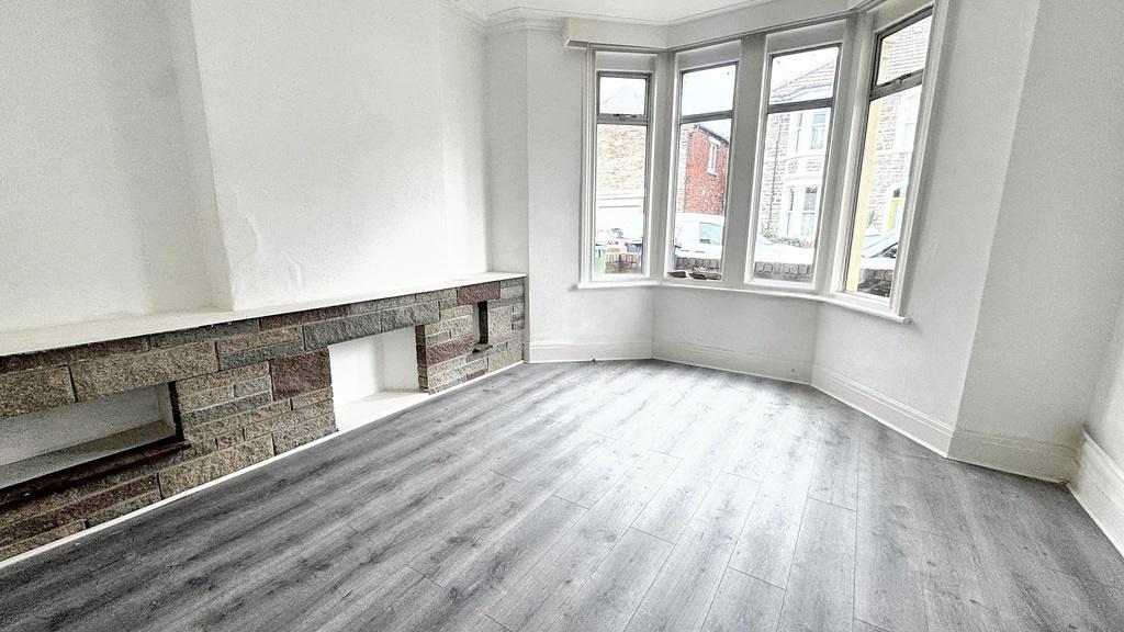 Bright front living room with large bay window,...