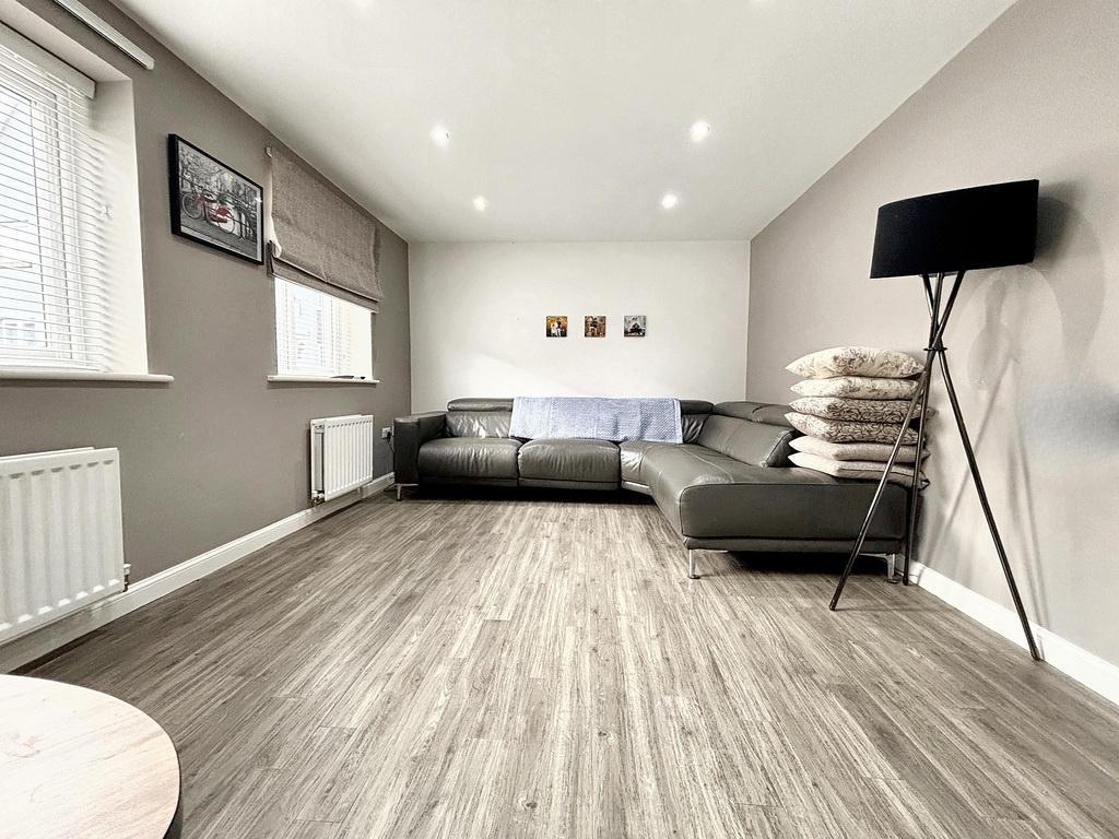 Bright, modern living room with a large L-shape...