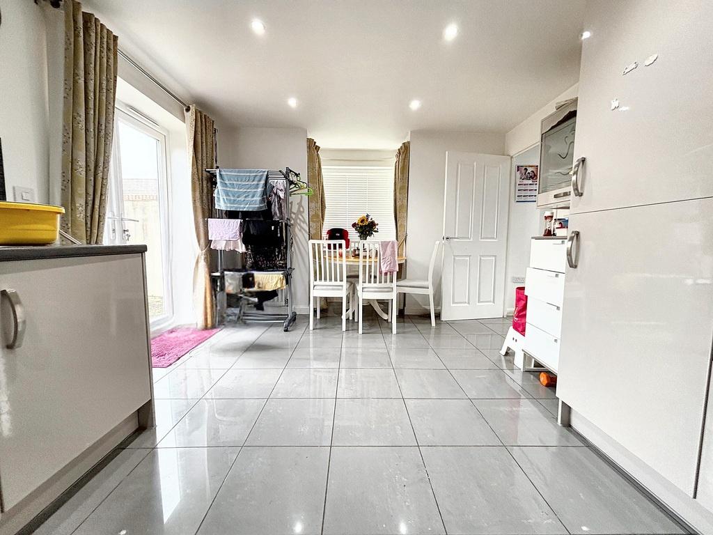 Bright modern kitchen with glossy tiled floor, ...