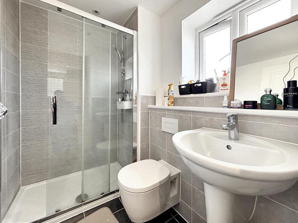 Modern tiled bathroom with a walk-in glass show...
