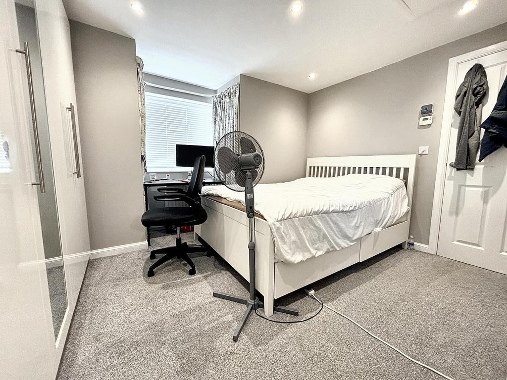 Bright, tidy bedroom with neutral decor, fitted...