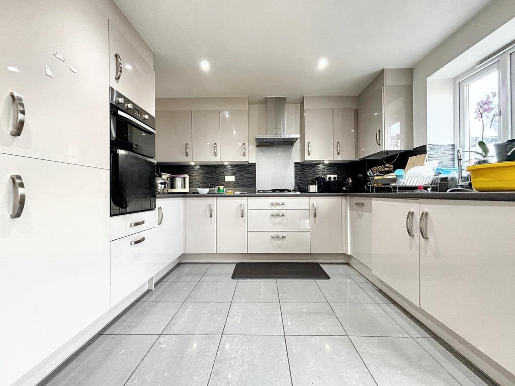Bright modern kitchen with glossy white cabinet...