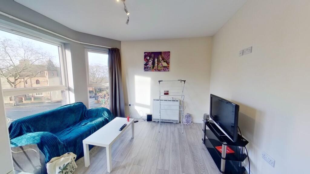 Bright, modern living room with large windows, ...