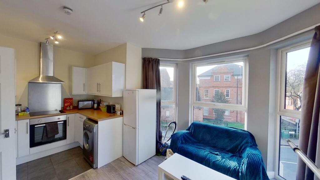 Bright open-plan living space with large bay wi...