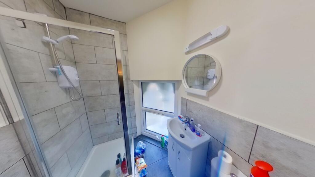 Bright modern bathroom with tiled shower-bath, ...