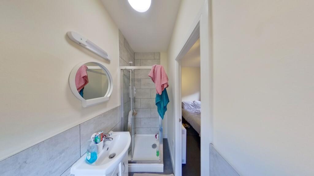 Bright, modern bathroom with a walk-in shower, ...