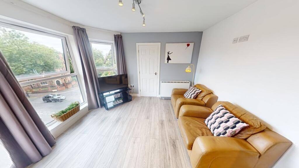 Bright, modern living room with large windows, ...