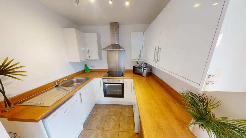 Bright, modern galley kitchen with wood-effect ...