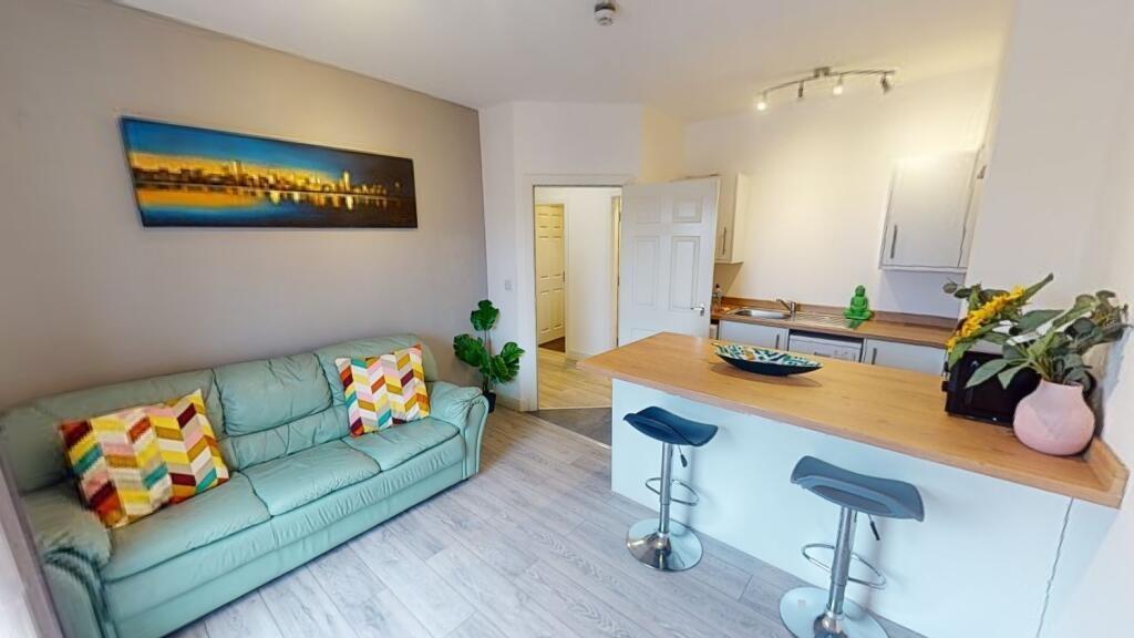 Bright, modern open-plan living area with a com...