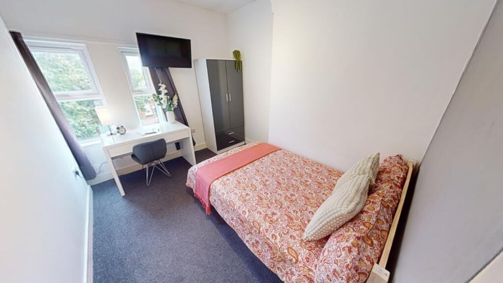 Bright, neatly presented bedroom with a double ...