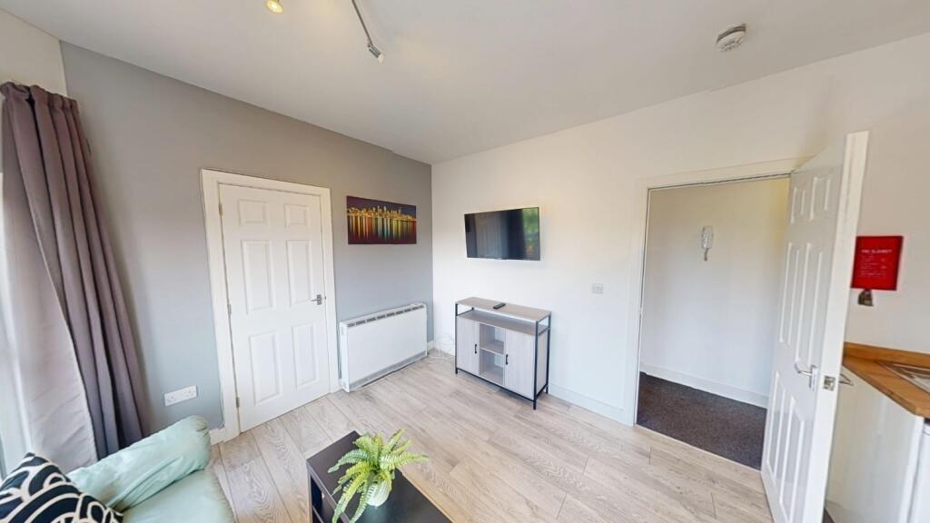 Bright, modern living room with light wood floo...