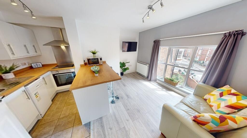 Bright open-plan living area with modern kitche...