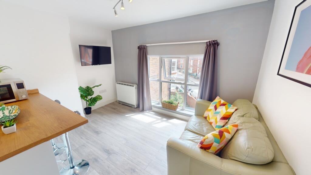 Bright, modern living room with a comfortable c...