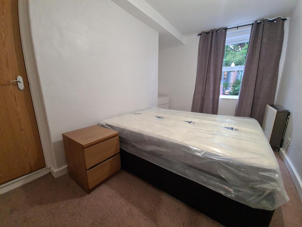 A welcoming bedroom featuring a comfortable dou...