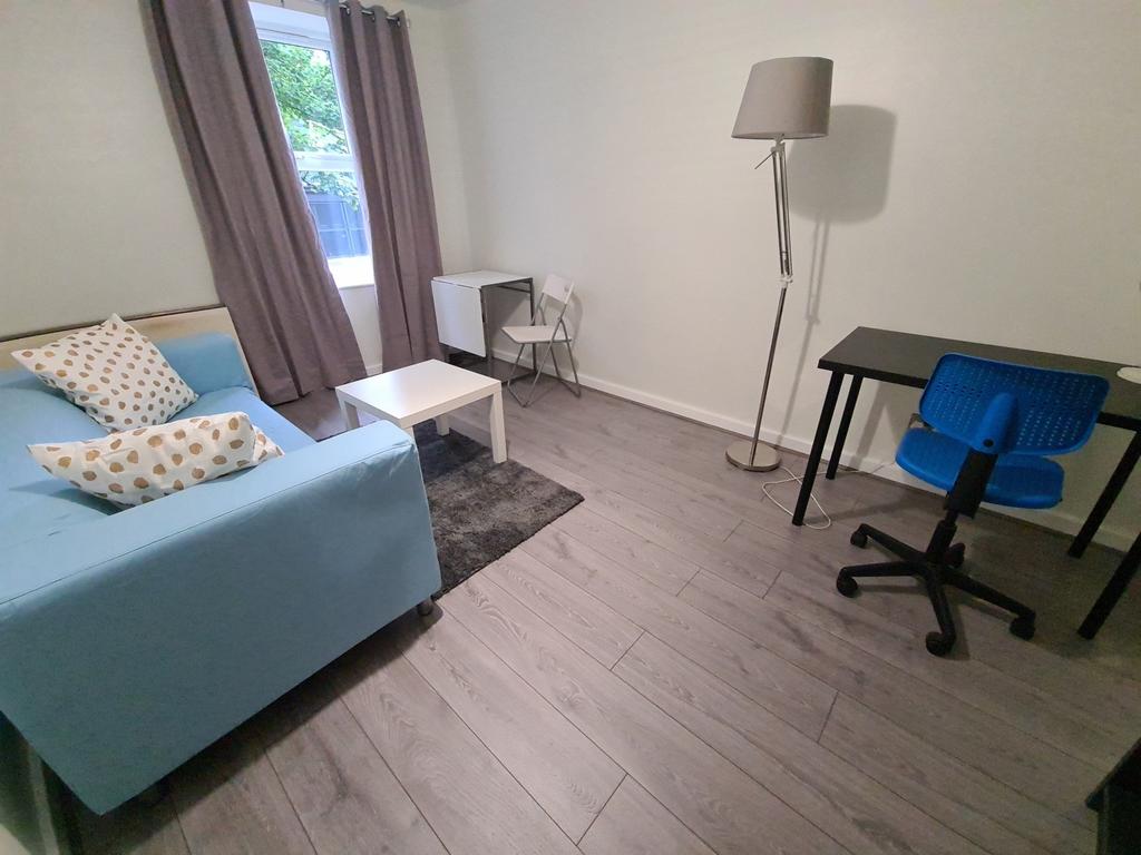 A bright and tidy single bedroom featuring a co...