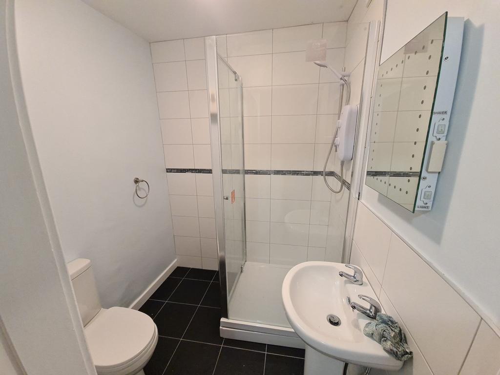 A clean and modern bathroom with a walk-in show...