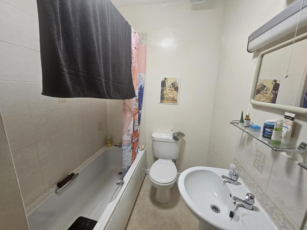 A well-maintained bathroom featuring a bathtub,...