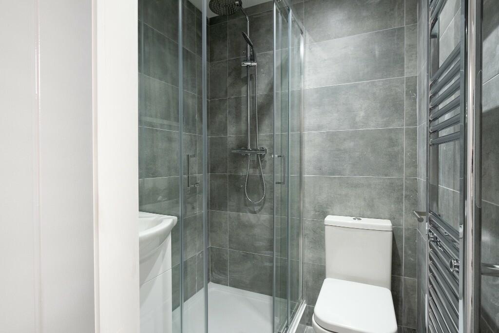 A modern, clean bathroom featuring a spacious s...