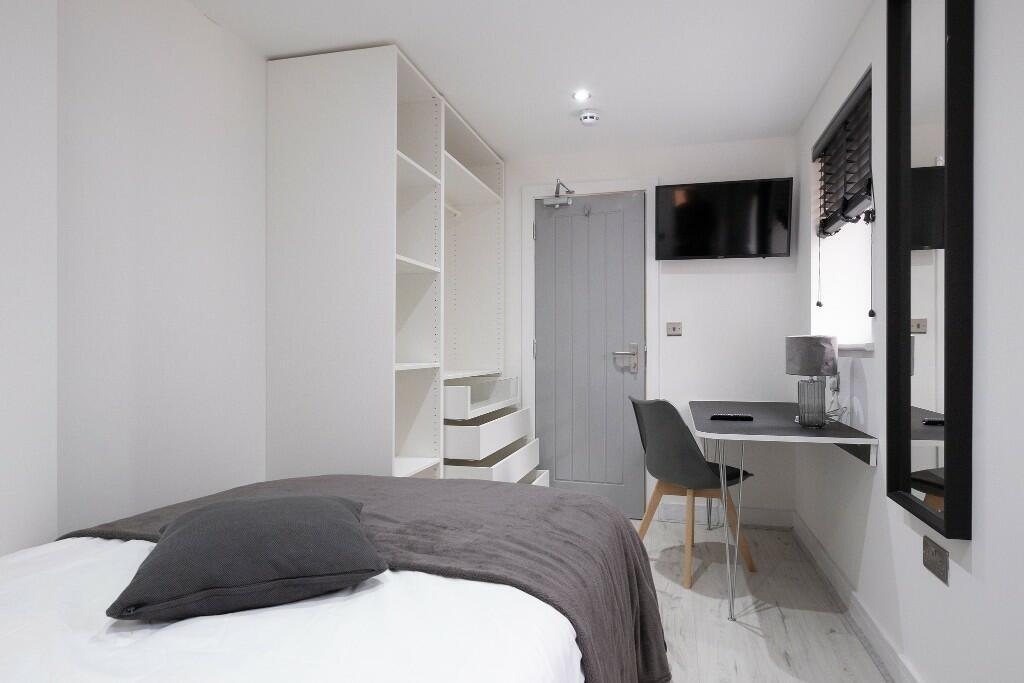 A well-maintained bedroom with a comfortable do...