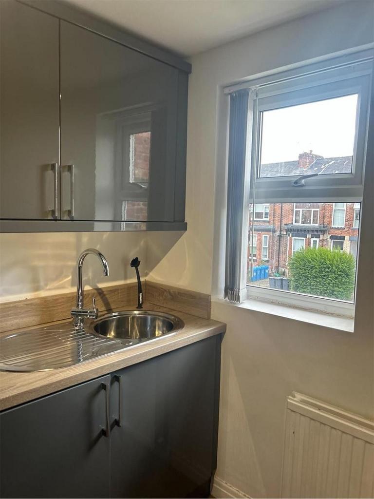 A bright and tidy kitchen area featuring a mode...