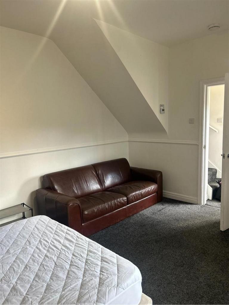 A well-maintained living room featuring a comfo...