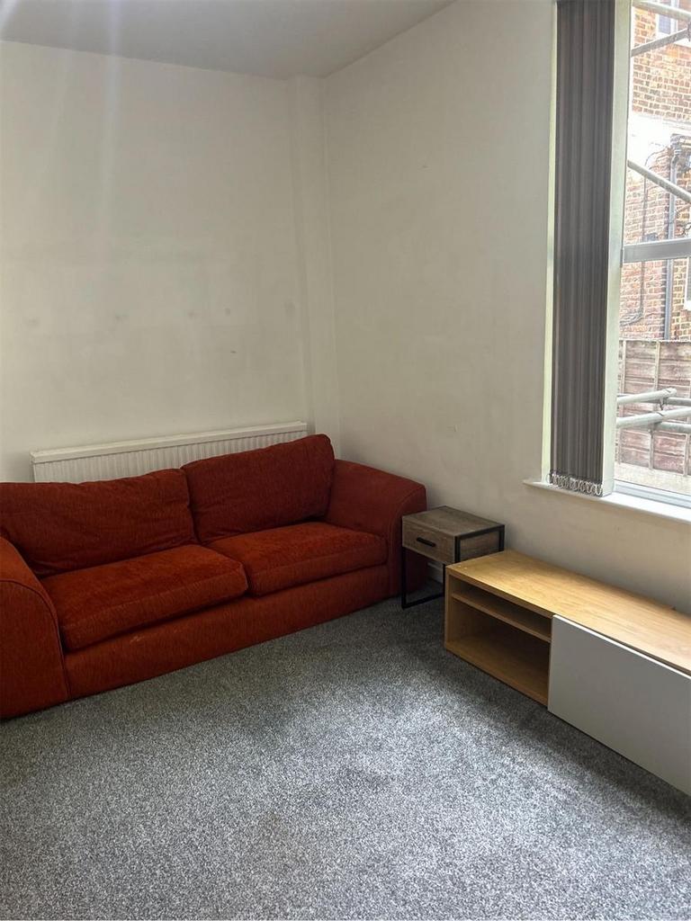 A spacious and welcoming living room featuring ...