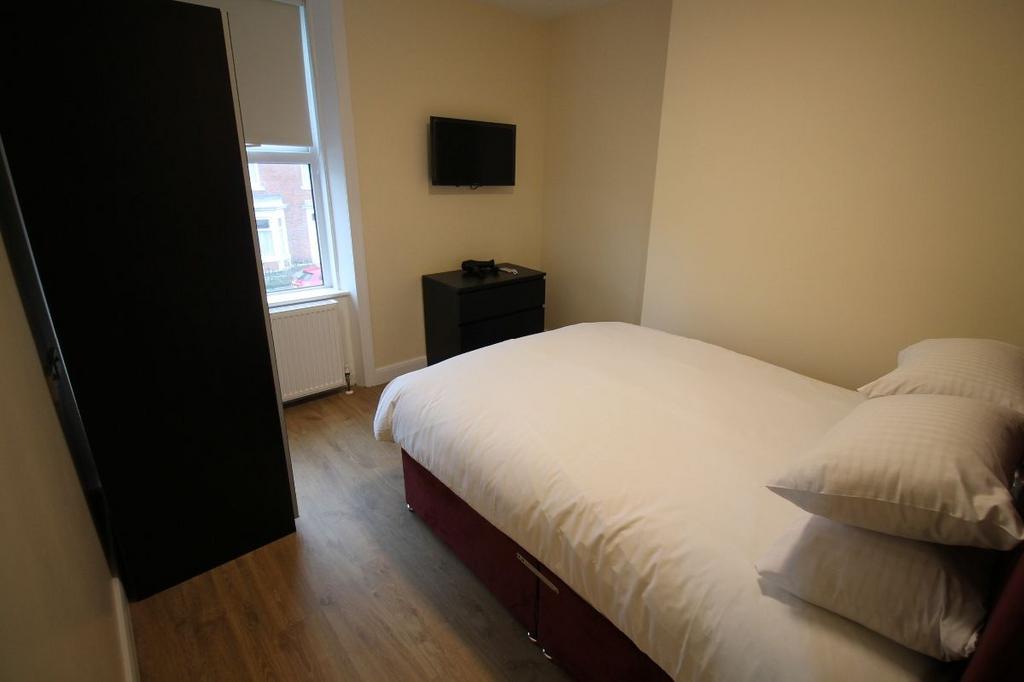 A bright, well-maintained bedroom featuring a c...