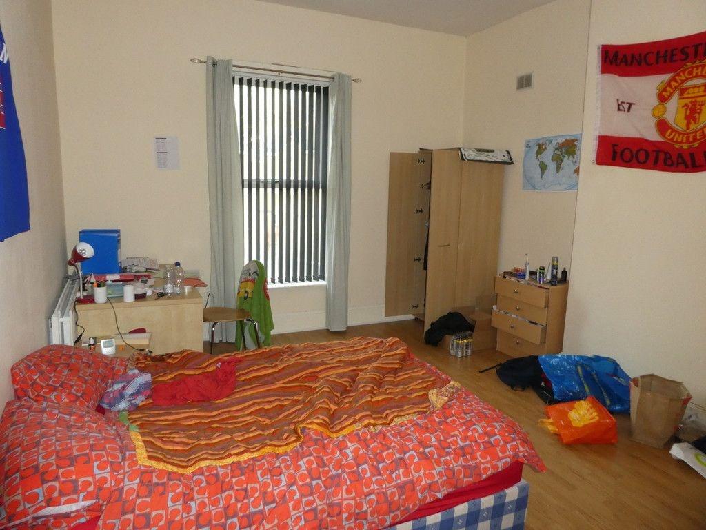 A cozy bedroom with a double bed, featuring a w...