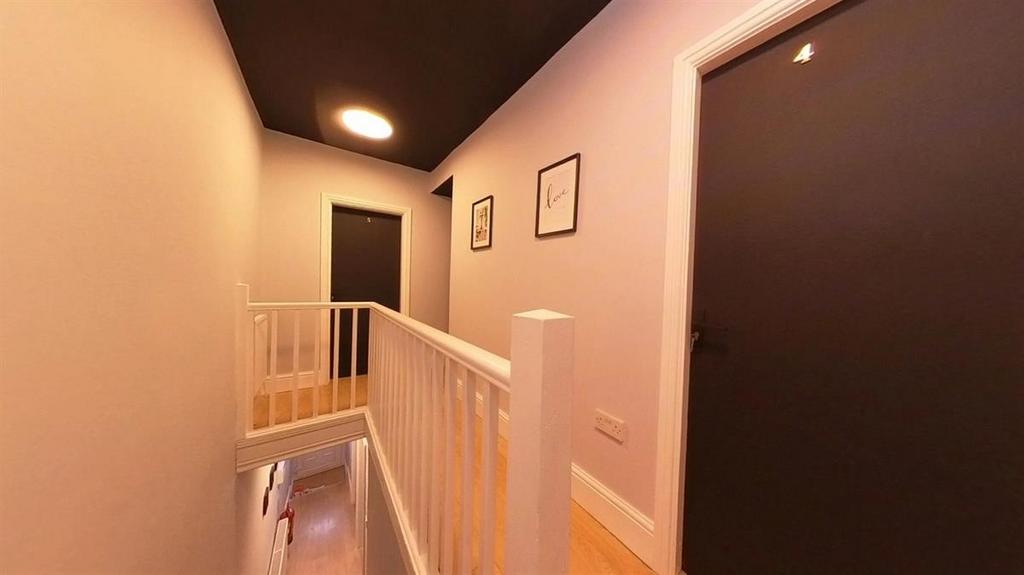 A well-maintained hallway illuminated by soft l...