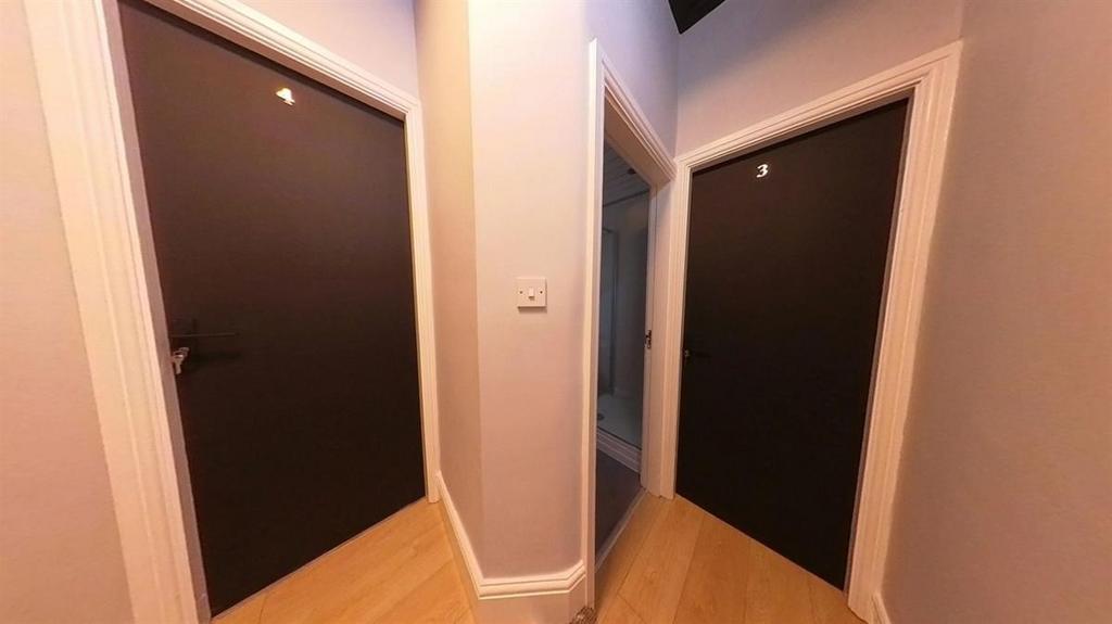 Well-kept hallway with three dark-panel doors, ...