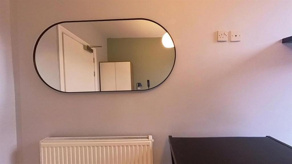 Neat bedroom corner with a large contemporary m...
