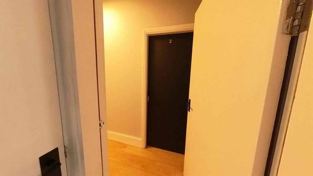 Well-maintained internal hallway with warm wood...