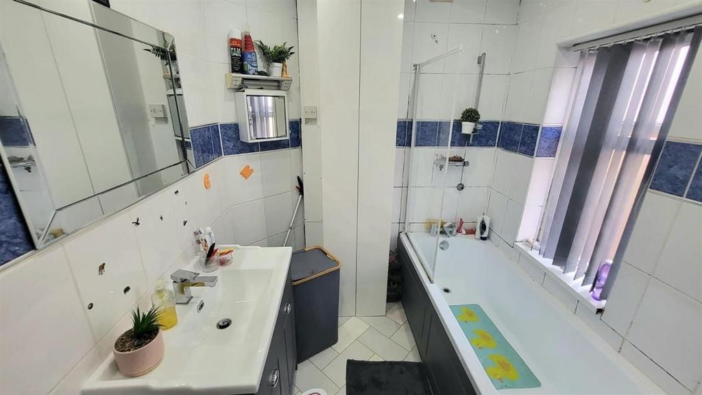 Bright, modern bathroom with a bathtub, separat...