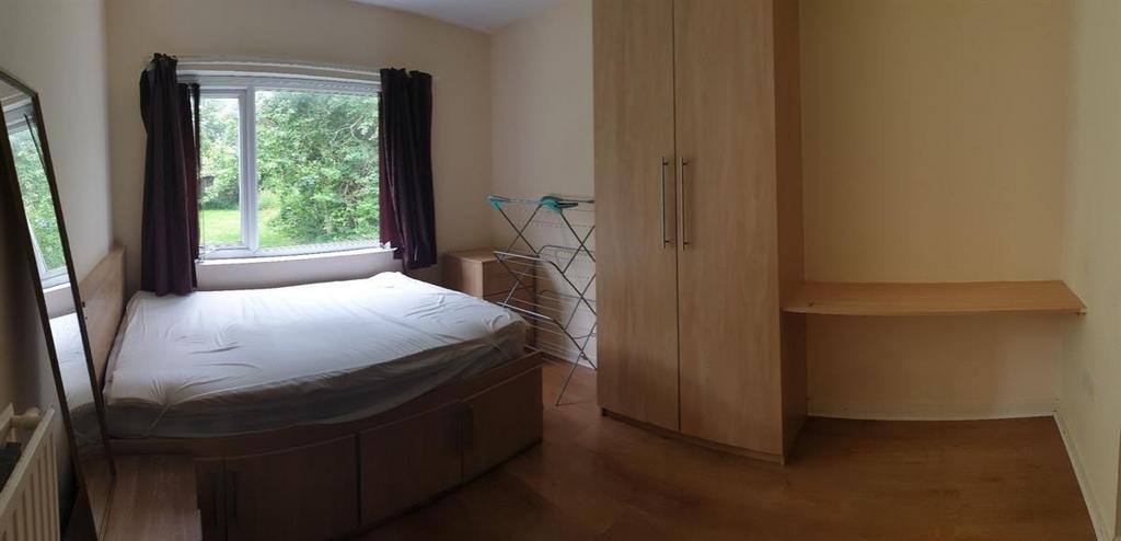 A well-maintained bedroom featuring a comfortab...