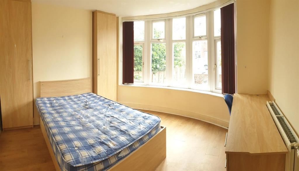 A bright and welcoming double bedroom featuring...