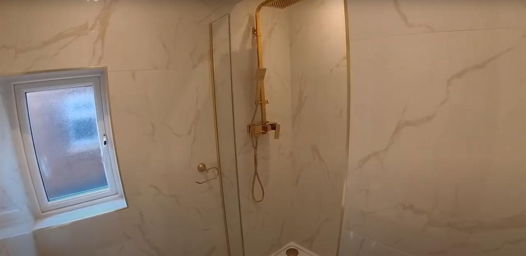 A spacious bathroom featuring a large bathtub a...