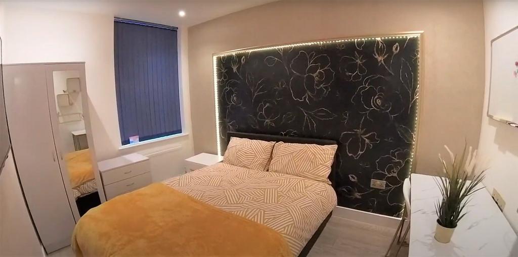 A cozy and well-maintained bedroom featuring a ...