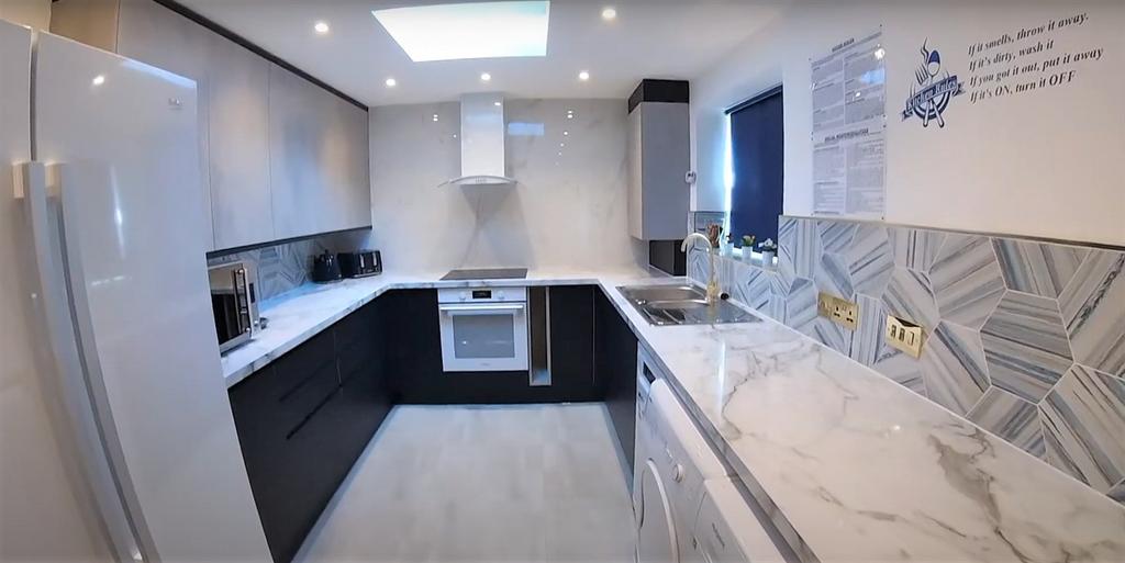 A modern, well-lit kitchen with sleek cabinetry...