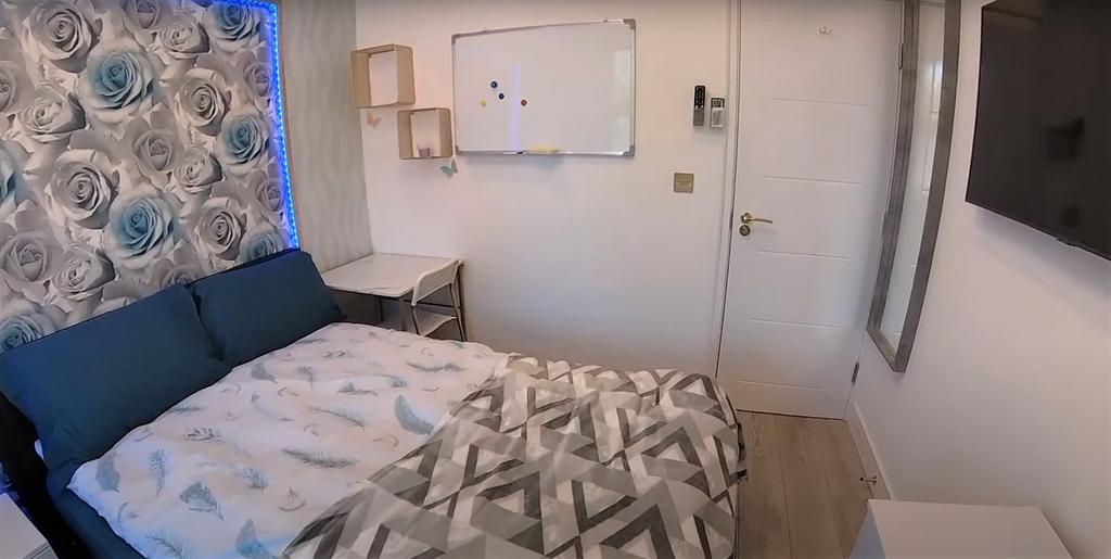A well-maintained bedroom with a comfortable do...